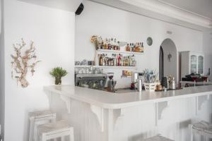 a white kitchen with a large white counter top at Hotel Mantalena in Antiparos Town