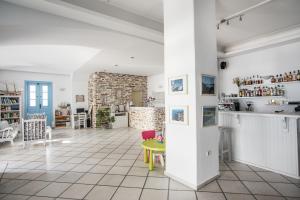 a living room with a yellow table and a brick wall at Hotel Mantalena in Antiparos Town