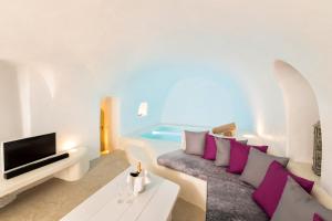 a living room with a couch and a tv at Kampanario Luxury Two-Bedroom Villa with Private Jacuzzi in Megalokhori