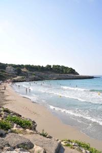 a group of people in the water at a beach at Camping Pascalounet in La Couronne