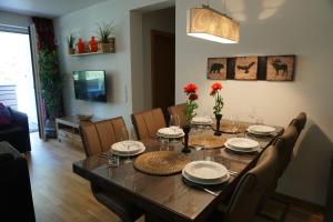 a dining room with a wooden table and chairs at Alpin & See Resort in Zell am See