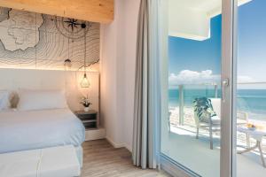 a bedroom with a bed and a view of the ocean at Hotel Elite in Caorle