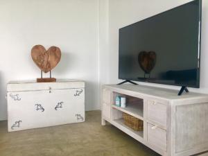 a living room with a television and a white dresser at Turquesa 1 Fuerteventura in Lajares