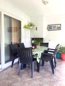 a dining table and chairs on a patio at Playa Esquirol in Cambrils