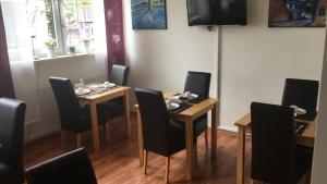a dining room with tables and chairs and a television at StadtHotel Bad Fallingbostel in Bad Fallingbostel