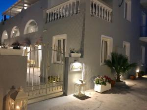 a white house with a gate and a plant at Sailor's Nautical Concept in Spetses