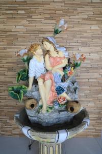 una estatua de dos mujeres sentadas en una fuente en Hotel Vicente de la Vega en Chiclayo