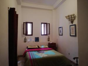 Postel nebo postele na pokoji v ubytování Riad Ben Youssef