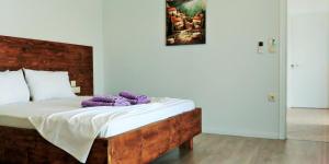 Un dormitorio con una cama con almohadas moradas. en Beleri House en Himare