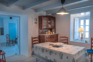 a living room with a table and a dining room at Lotus Sweet Home Hydra in Hydra