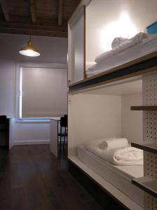 エステーリャにあるAgora Hostelの二段ベッド2台とテーブルが備わる客室です。
