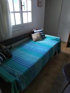 ガラタスにあるThe Olive Branchの青い毛布が付いた部屋のベッド1台分です。