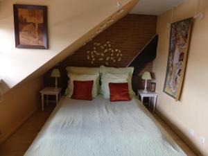 a bedroom with a large bed in a attic at La Fabiola in Colmar