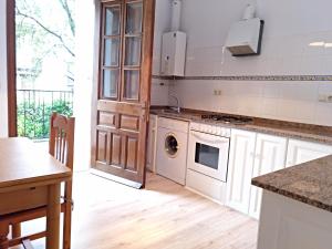 a kitchen with a washer and dryer in it at AT Villa Manola in Colombres