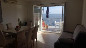 a living room with a table and a view of the ocean at Apartment Adam in Zavalatica