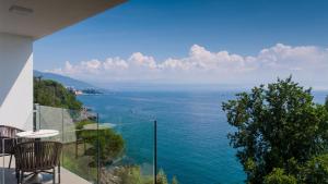 a view of the ocean from a house at Boutique Hotel Acacia in Lovran