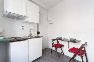 a kitchen with two chairs and a table at Studio Meublé in Gentilly