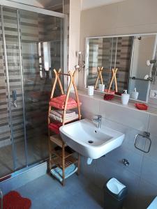 a bathroom with a sink and a shower at Sea-esta 1 in Valun