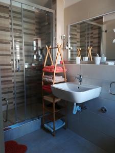 a bathroom with a sink and a shower at Sea-esta 1 in Valun