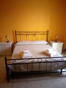 a bed with a white bedspread and pillows at B&B Vista Fiume in Bosa