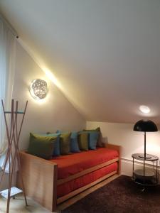 a bed with colorful pillows in a room at Casal do Arcebispado in Felgueiras