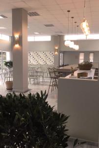 a large room with tables and chairs in a building at Fourtounis Hotel in Kefalos