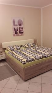 a bed sitting in a room with at Apartment Smajlovic in Kukci