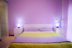 a bedroom with a bed with two lamps on it at As Easy in Assisi