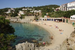 a group of people on a beach in the water at Apartamento con WiFi y Aire acondicionado en Pals Playa in Pals