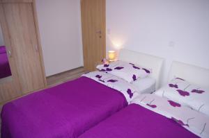 Posteľ alebo postele v izbe v ubytovaní Apartment LuMaGo