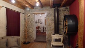 a living room with a couch and a stove at Le pré aux clercs in Trévignin