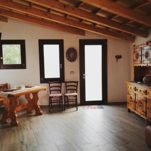 a living room with a table and chairs and windows at SA DOA in Baratili San Pietro +20 photos