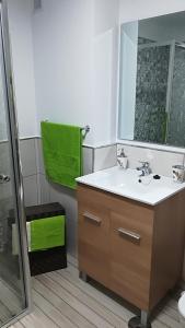 a bathroom with a sink and a mirror and a shower at casa quintana in Arinaga