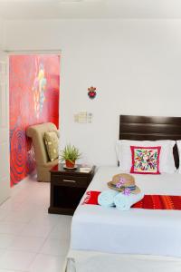 a bedroom with a bed with a plate of food on it at CASA FRIDA FULL APARTMENTS holbox in Holbox Island