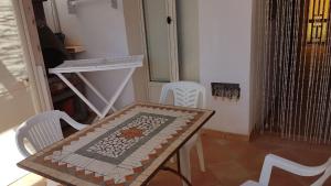 a table and chairs in a small room with a table and a table and chairs at Lampedusa Vacanza in Lampedusa