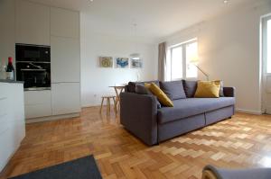 a living room with a couch and a kitchen at Downtown Cathedral Apartment in Braga