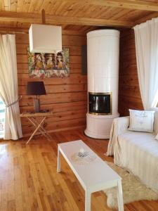 a living room with a couch and a fireplace at Lakeshore house in Dvarčėnai
