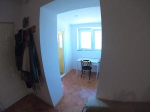 a hallway with a table and a chair in a room at Mazurska Kwatera-Rezerwat Fuledzki Róg in Giżycko
