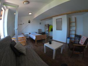 a living room with a couch and a table at Mazurska Kwatera-Rezerwat Fuledzki Róg in Giżycko