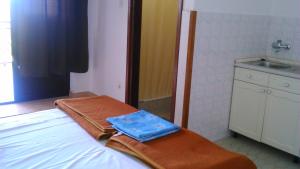 a room with a bed with a sink and a sink at Apartmani Ana Novi V. - studio in Novi Vinodolski