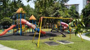 a playground in a park with slides and swings at Apartment Next to Unifi Arena Axiata, Stadium Bukit Jalil in Kuala Lumpur