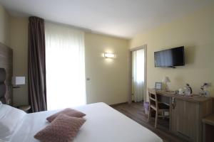 a hotel room with a bed and a desk and a television at "Il Viottolo" Rooms in Roccaraso