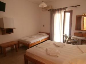 Ένα ή περισσότερα κρεβάτια σε δωμάτιο στο Ξενοδοχείο Άρης