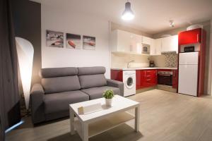 a living room with a couch and a table at Apartamentos Fabiola in Cambrils