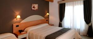 Rúm í herbergi á Hotel Il Cammino Di Francesco
