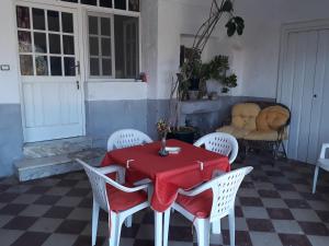 a table and chairs with a red table cloth on it at Tenuta Argiano in Mesagne