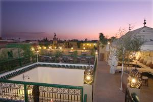 a view of a balcony with a swimming pool at night at Riad Karmela in Marrakesh