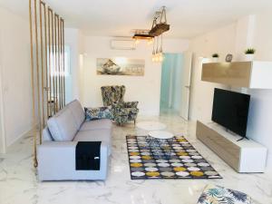 a living room with a couch and a tv at New central 2BR apartment 100m-to-beach free parking in Fuengirola