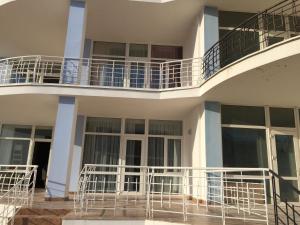 a white building with balconies on the side of it at Town-house Golden Bugaz in Karolino-Buhaz
