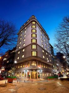 Un grand bâtiment avec des lumières sur son côté dans l'établissement Midtown Hotel, à Istanbul